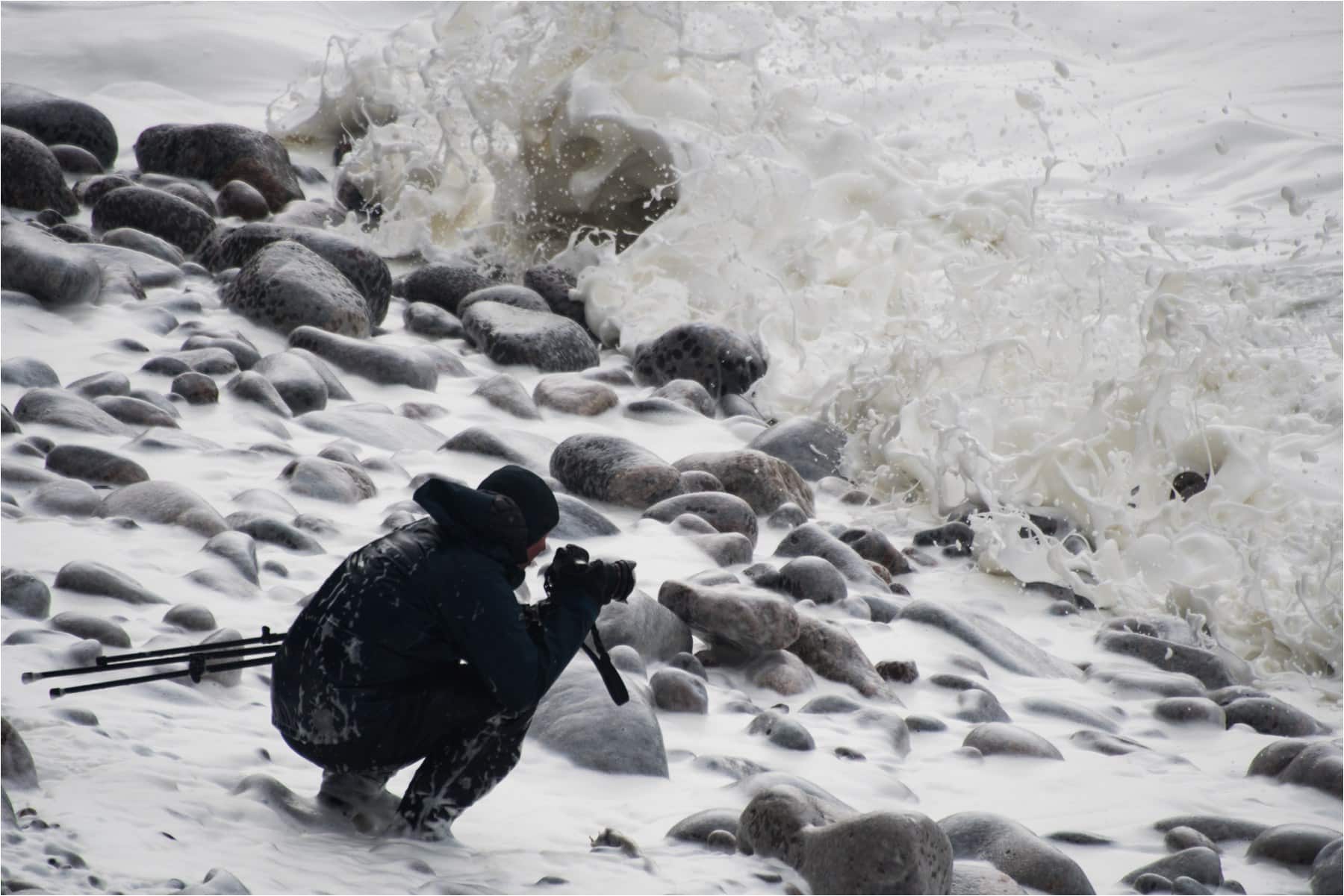 photographer photographing by the sea in a storm 